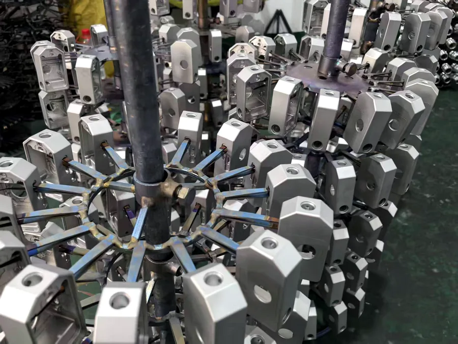 Aluminum CNC components on an anodizing fixture